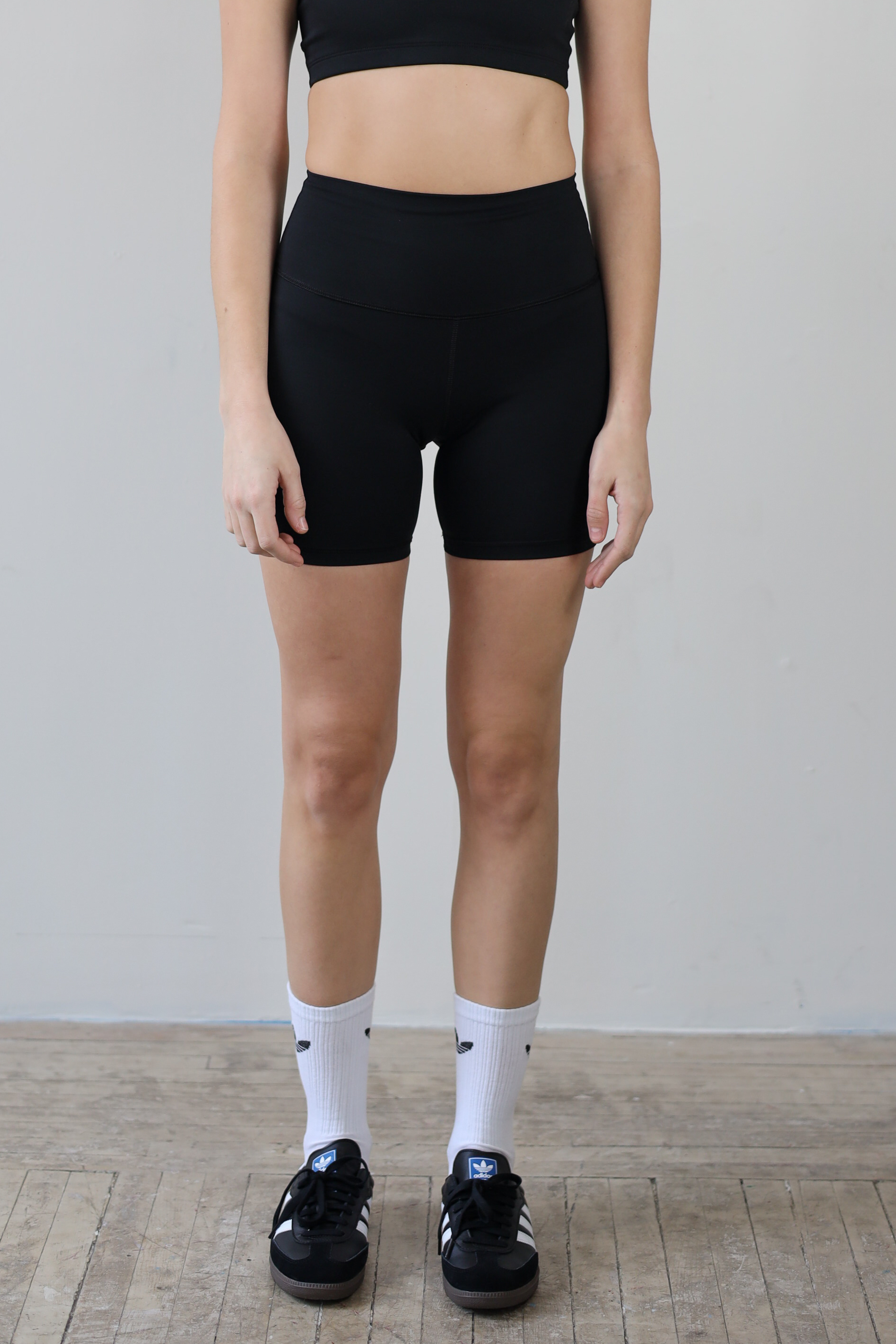 Premium black high-waisted bike shorts for wholesale – buttery-soft, squat-proof, and moisture-wicking. Perfect for brands to customize and private label. Designed for ultimate comfort and performance in athleisure and activewear collections.