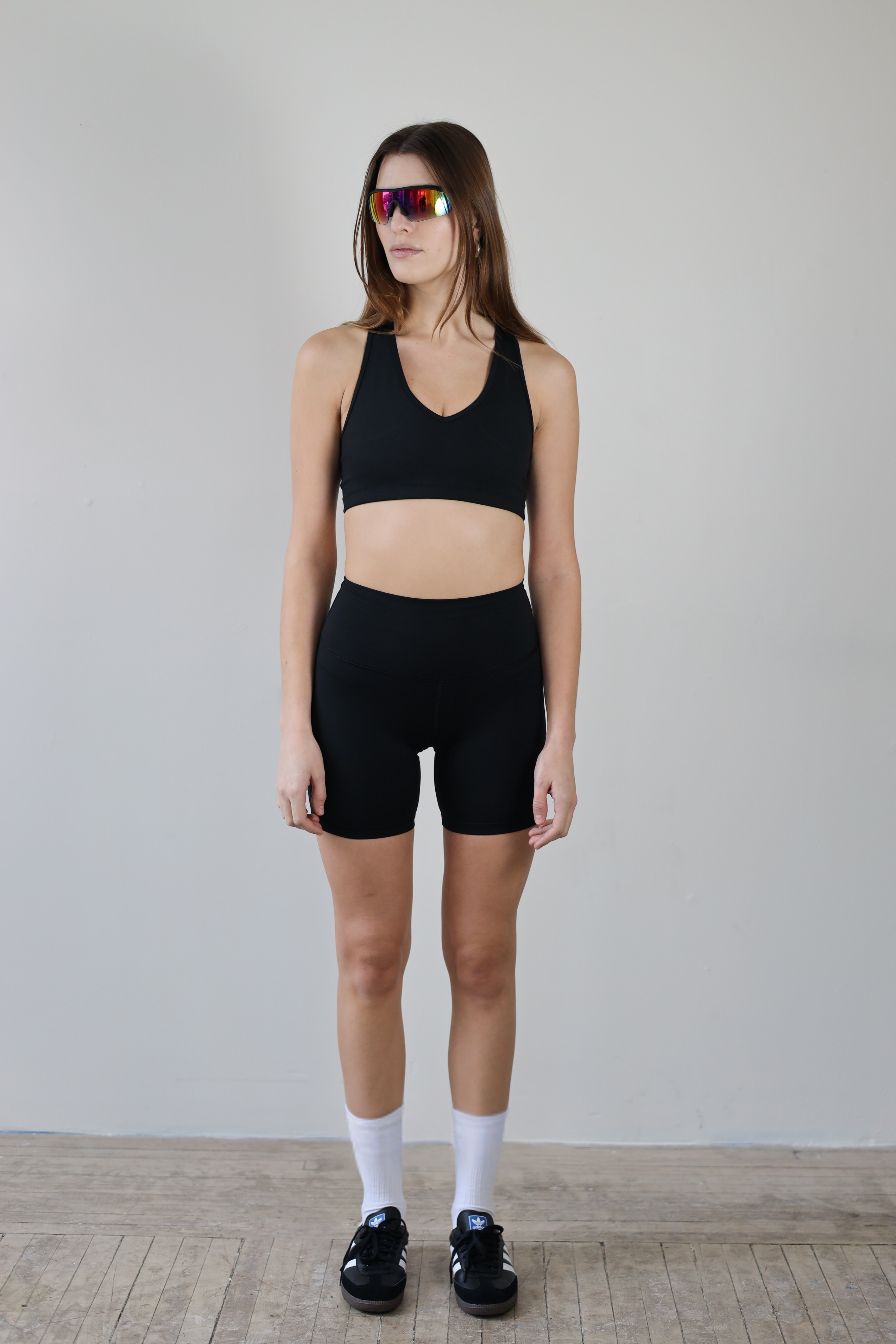 Wholesale black V-neck sports bra for brands – buttery-soft, moisture-wicking, and breathable. Designed for private labeling and custom branding, perfect for activewear and athleisure collections. High-stretch, eco-conscious fabric for all-day comfort and performance