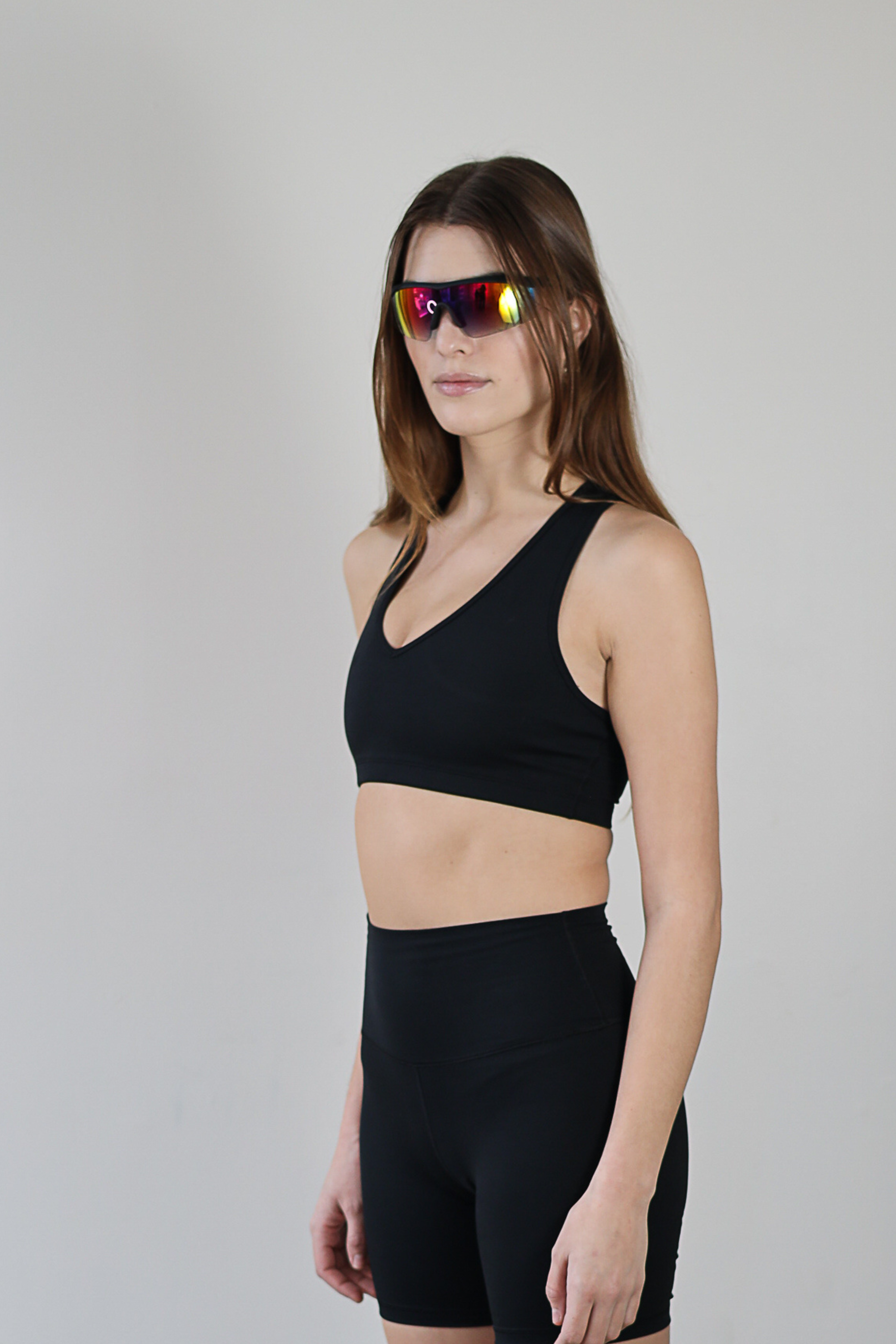 Wholesale black V-neck sports bra for brands – buttery-soft, moisture-wicking, and breathable. Designed for private labeling and custom branding, perfect for activewear and athleisure collections. High-stretch, eco-conscious fabric for all-day comfort and performance