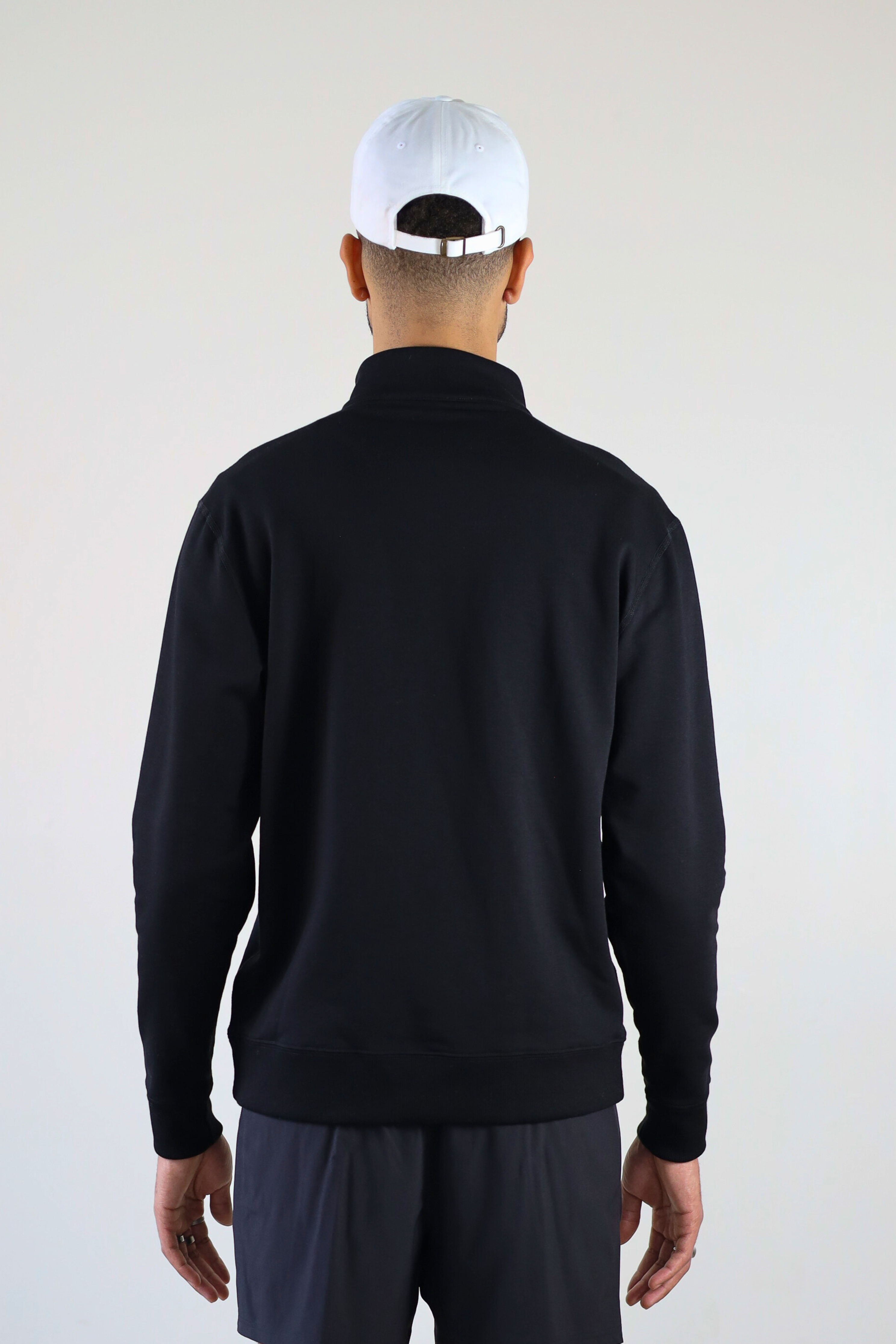 Men’s 1/4 Zip Crewneck in Black – back view on model displaying modern boxy cut and seam detailing
