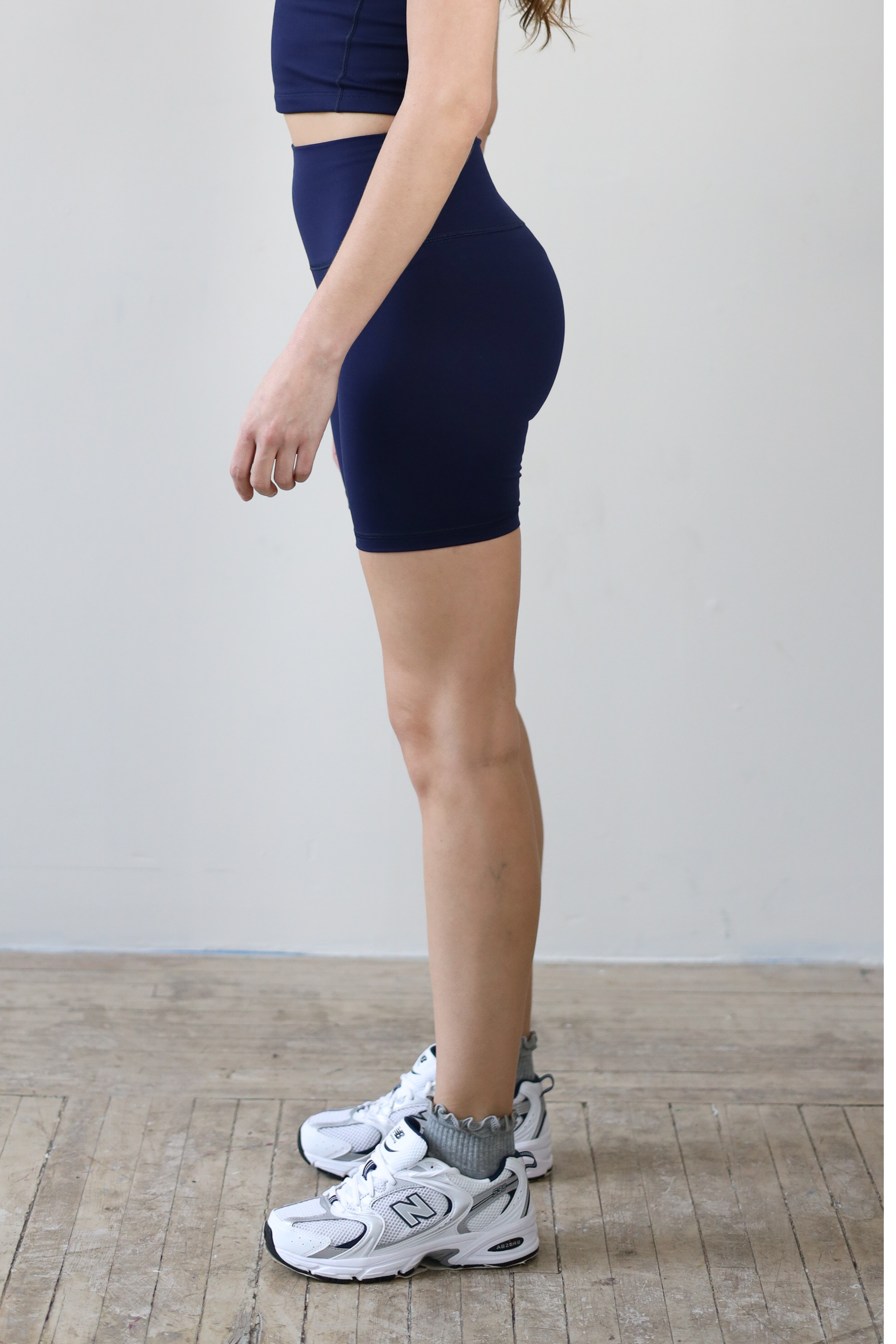 High-waisted navy bike shorts for wholesale – buttery-soft, squat-proof, and moisture-wicking. Perfect for brands to customize and private label. Designed for premium comfort and performance in athleisure and activewear collections.