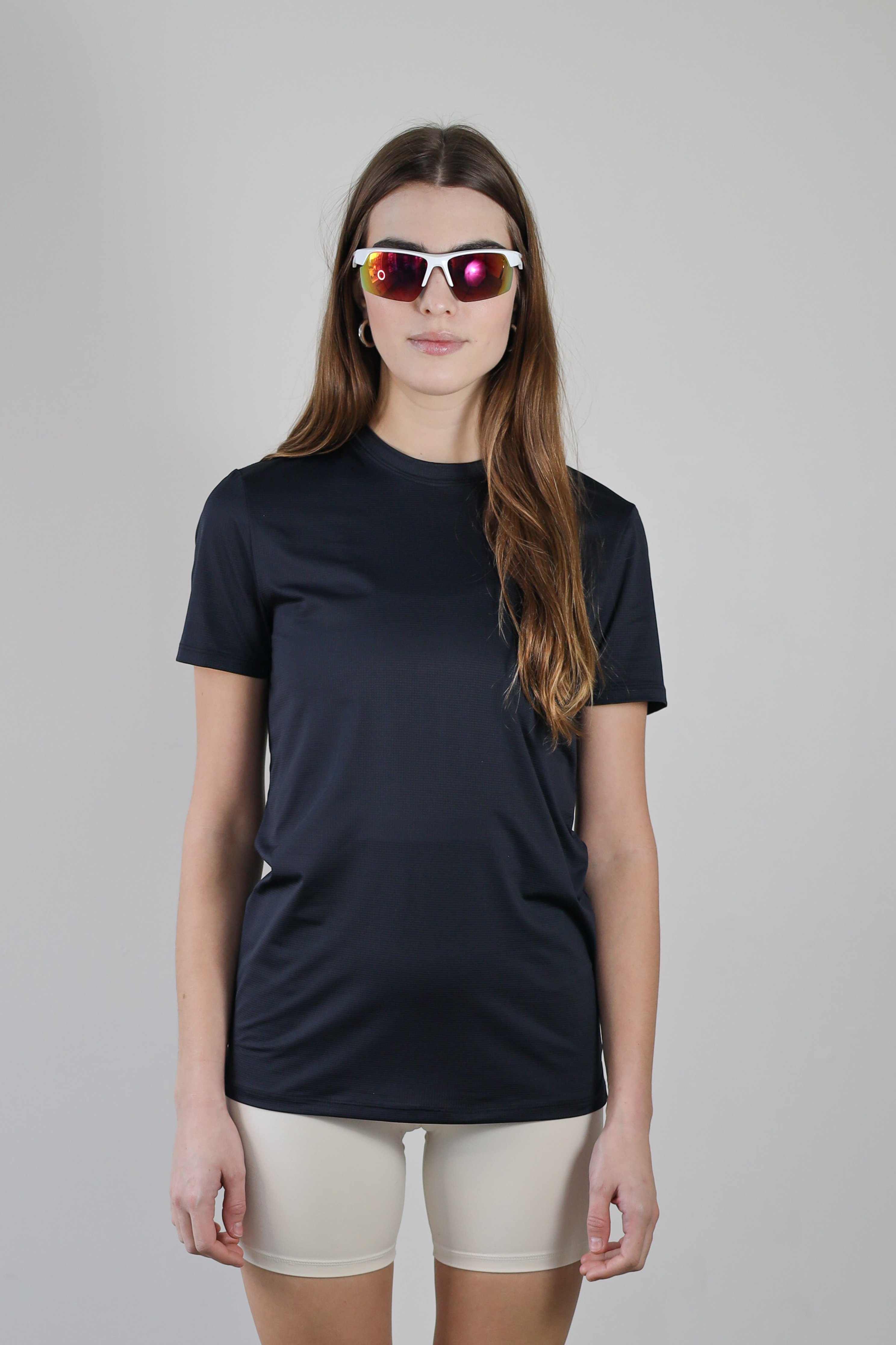 A model wearing the Unisex Short Sleeve Runners Tee in black, standing front-facing to showcase the sleek, athletic fit and lightweight, moisture-wicking fabric for all-day performance.