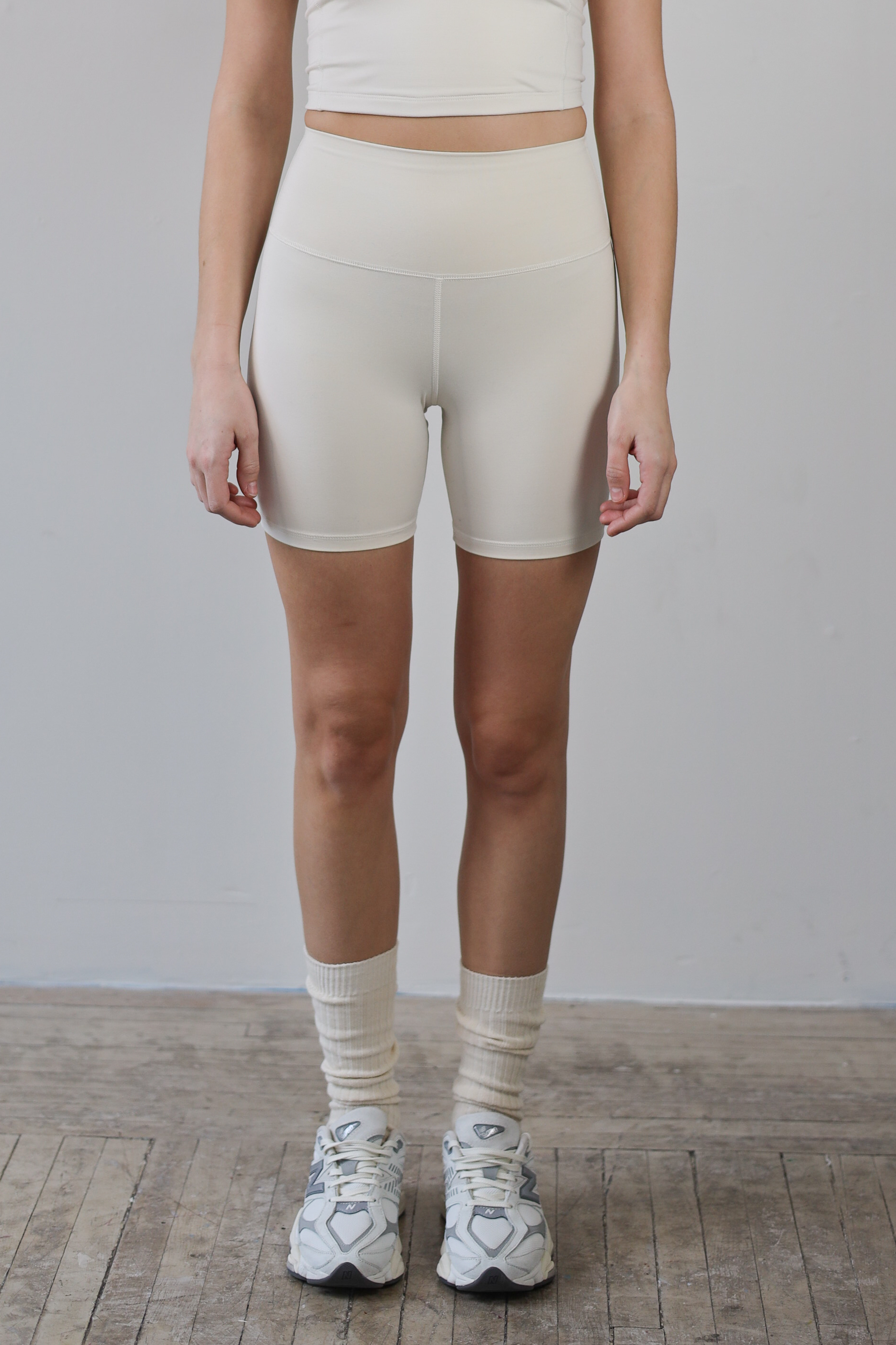 High-waisted ecru bike shorts for wholesale – buttery-soft, squat-proof, and moisture-wicking. Perfect for brands to customize and private label. Designed for premium comfort and performance in athleisure and activewear collections