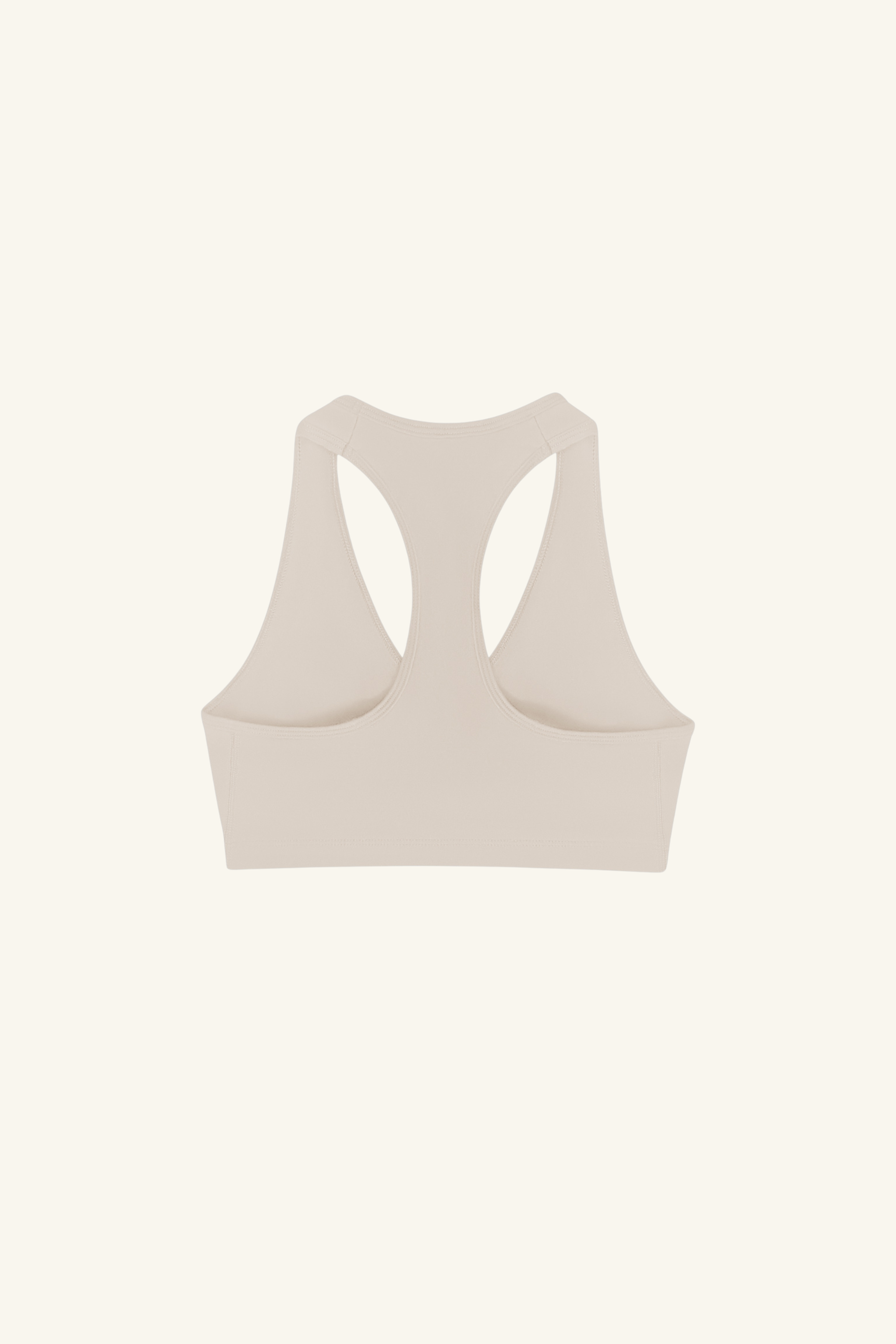 Wholesale ecru V-neck sports bra for brands – buttery-soft, breathable, and moisture-wicking. Perfect for private labeling and custom branding, designed for activewear and athleisure collections. High-stretch, eco-conscious fabric for comfort and performance.