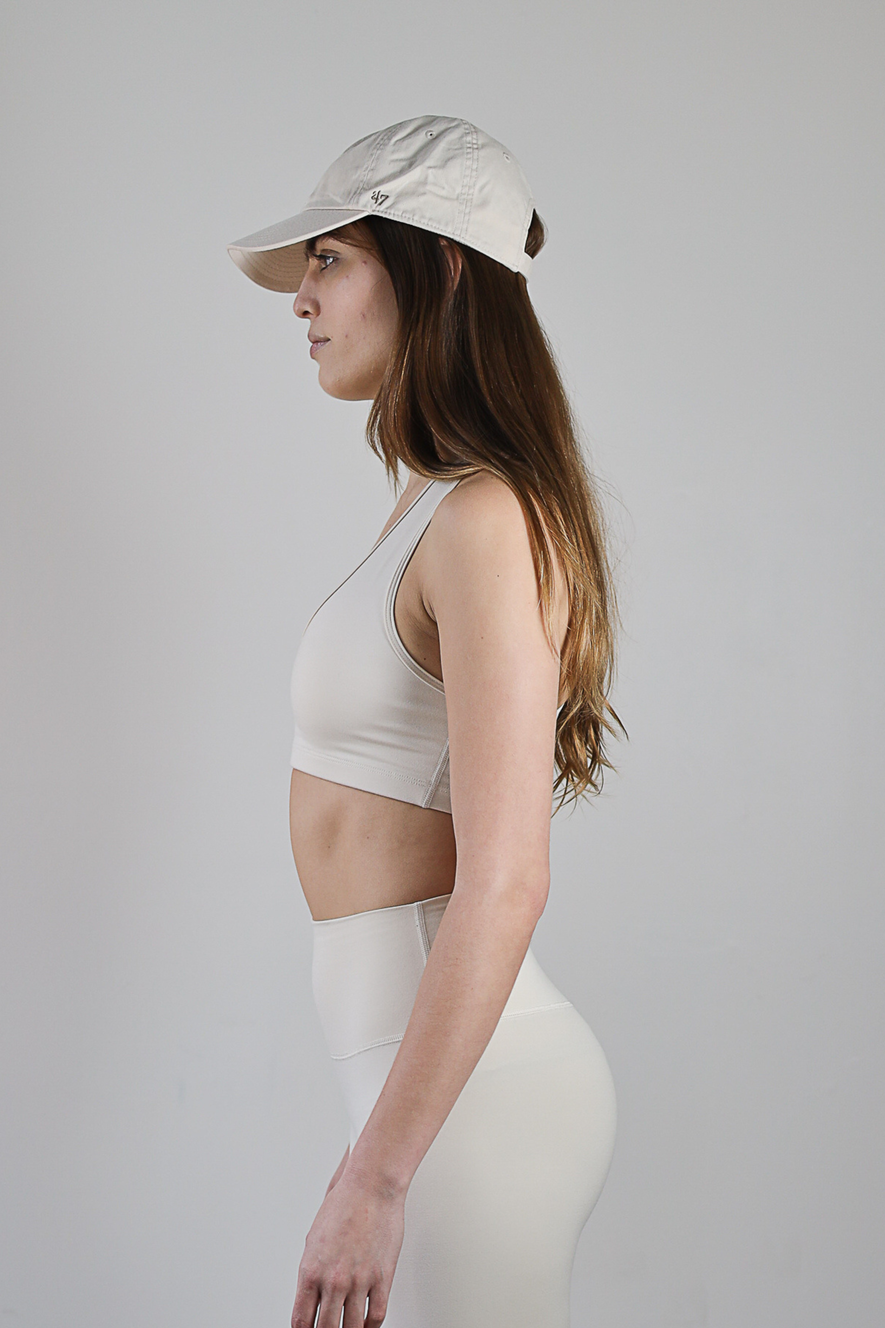 Wholesale ecru V-neck sports bra for brands – buttery-soft, breathable, and moisture-wicking. Perfect for private labeling and custom branding, designed for activewear and athleisure collections. High-stretch, eco-conscious fabric for comfort and performance.